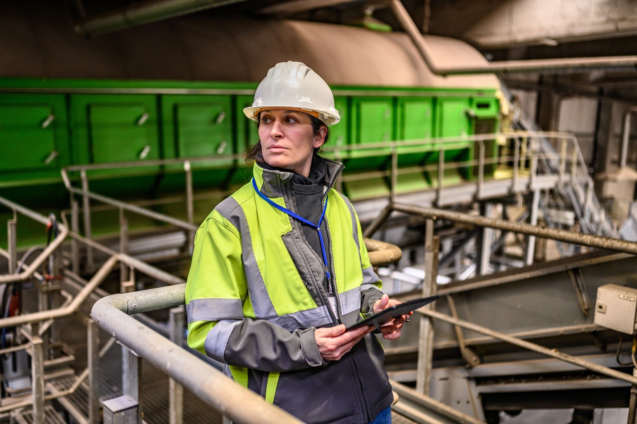 Industrial technician monitoring equipment with a tablet